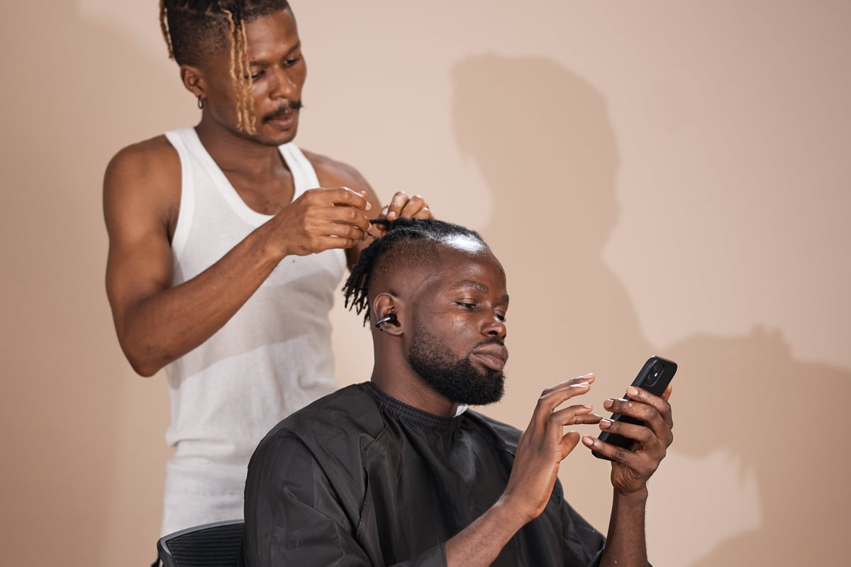 Mobile barber styling a client's hair