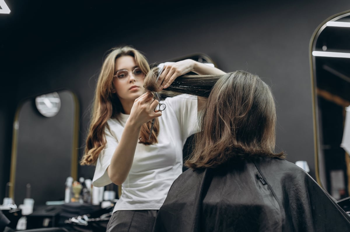 Barber cutting a client's hair in a modern barbershop